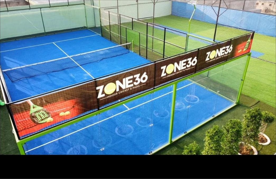 Zone 36's blue glass-walled padel court with branded surrounds
